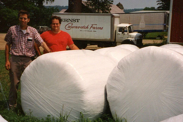 Ernst founders standing next to wrapped bales