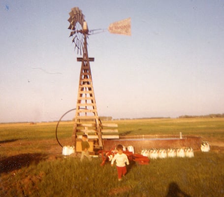 A child in front of the windmill in Nebraska